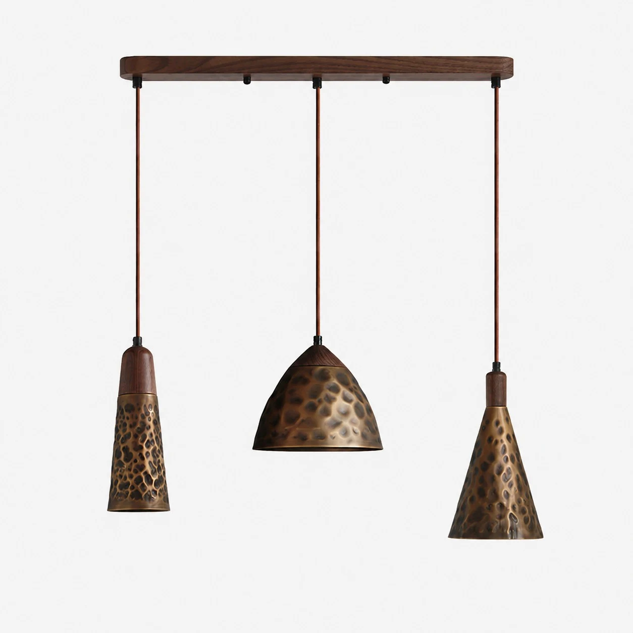 Mixed three-light hammered copper pendant on walnut ceiling base