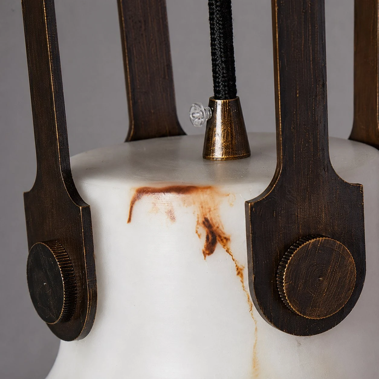 Dark metal side hardware and marble-look shade detail