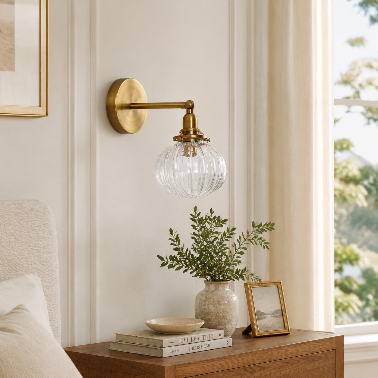 Vintage brass wall light above a styled bedside table