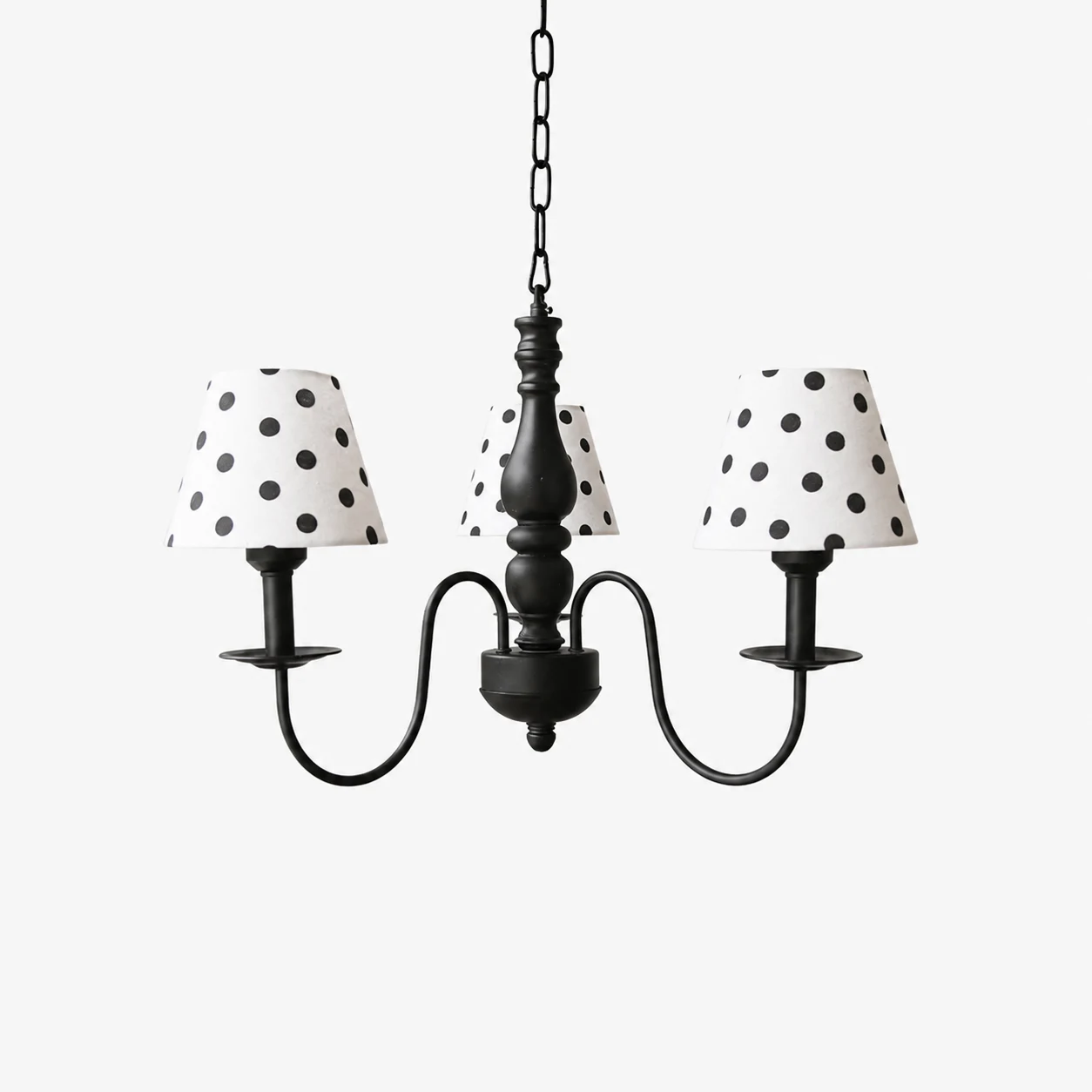 Three-light black chandelier with cream polka dot fabric shades