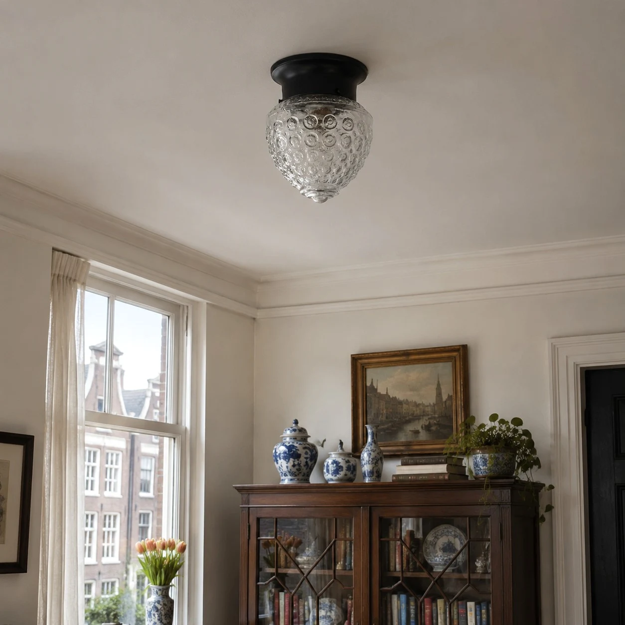 Glass ceiling lamp installed close to the ceiling in a classic room