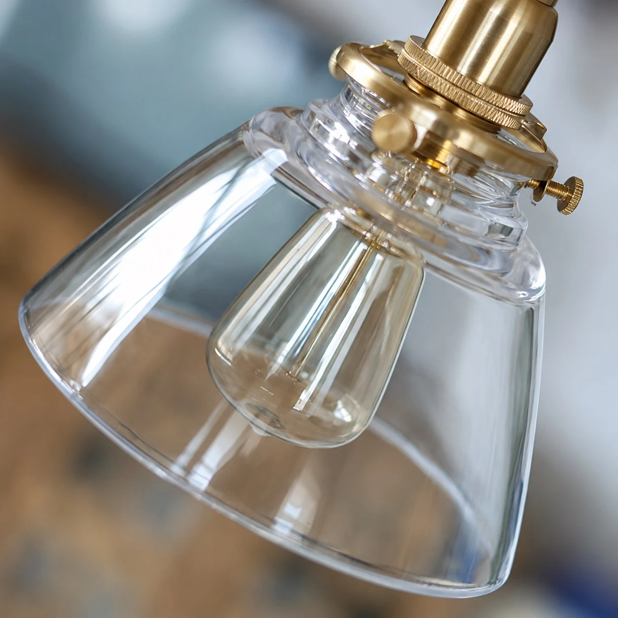 Close view of brass socket and clear glass shade