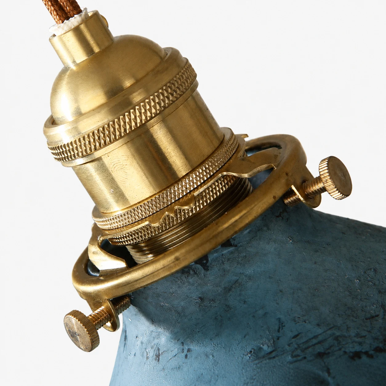 Close view of brass tone lamp holder and clamp hardware