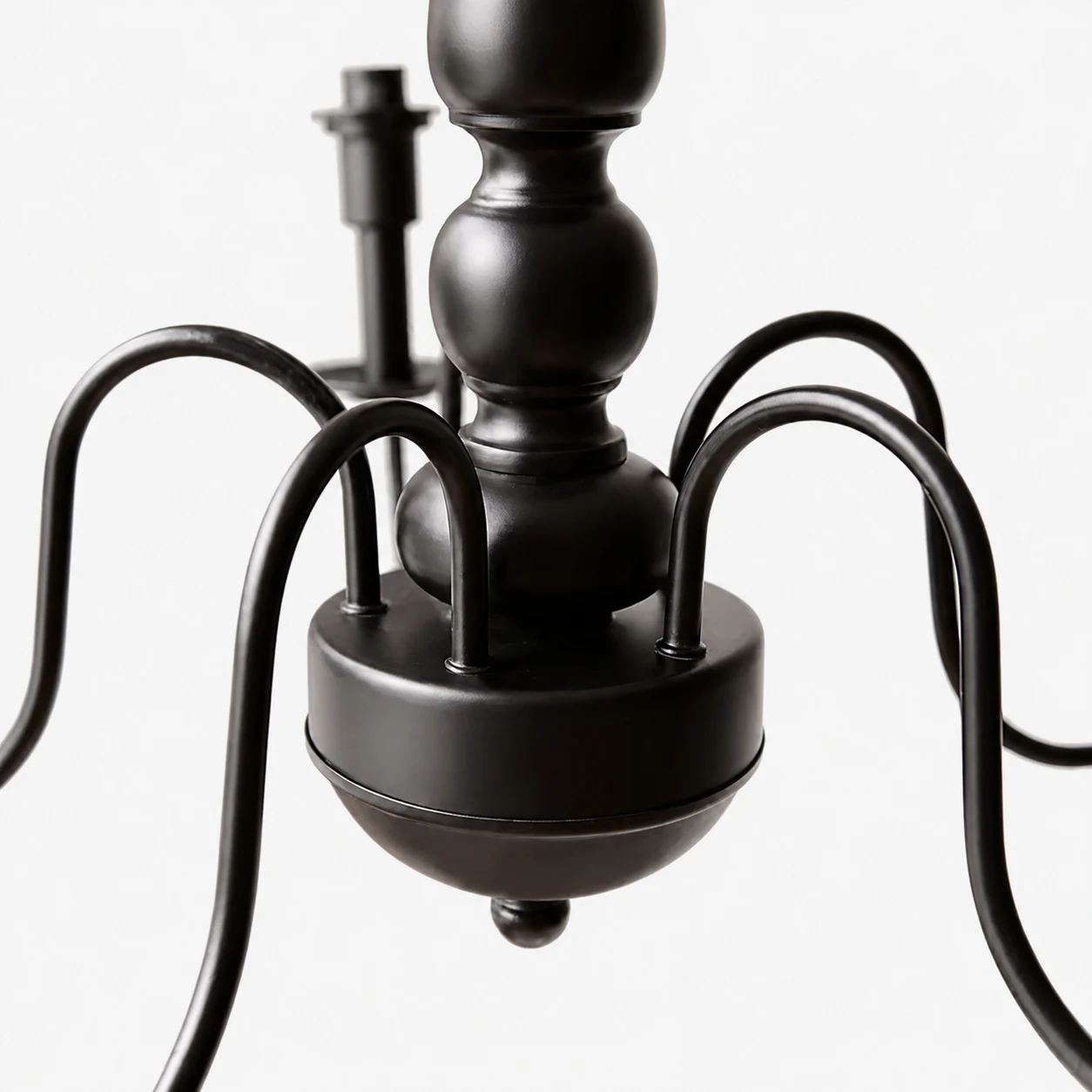 Close view of the black curved chandelier arms and central body