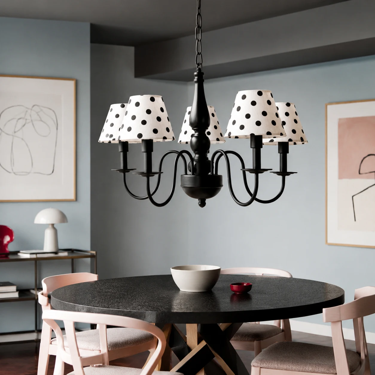Five-light polka dot chandelier installed above a round dining table