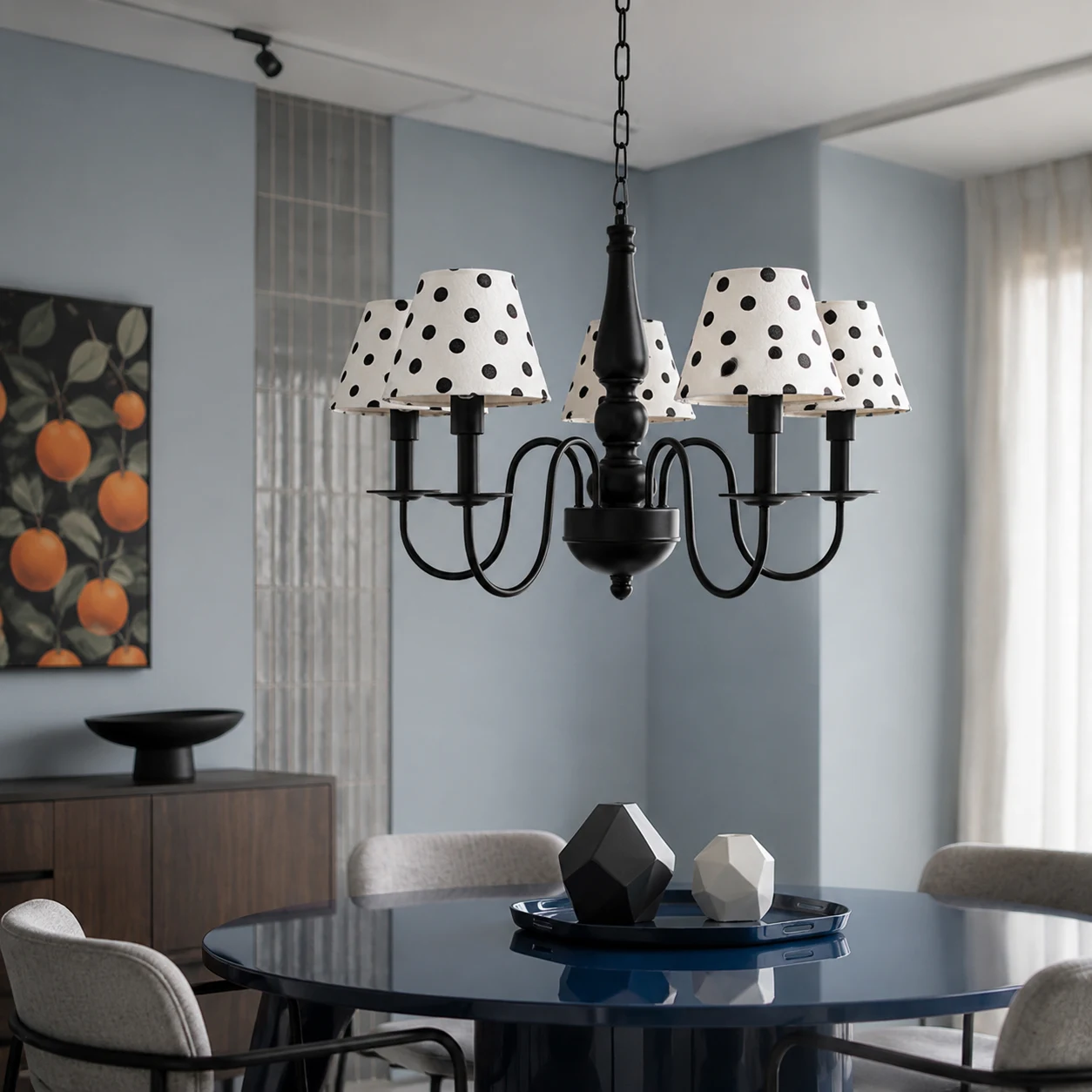 Black polka dot chandelier above a modern dining table