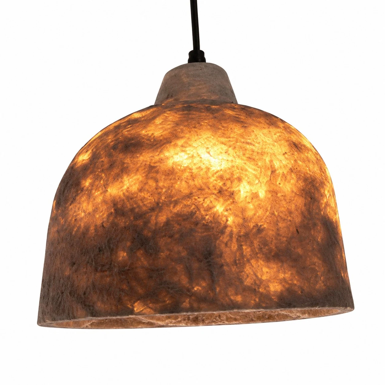 Warm glowing paper pendant shade showing natural fiber texture