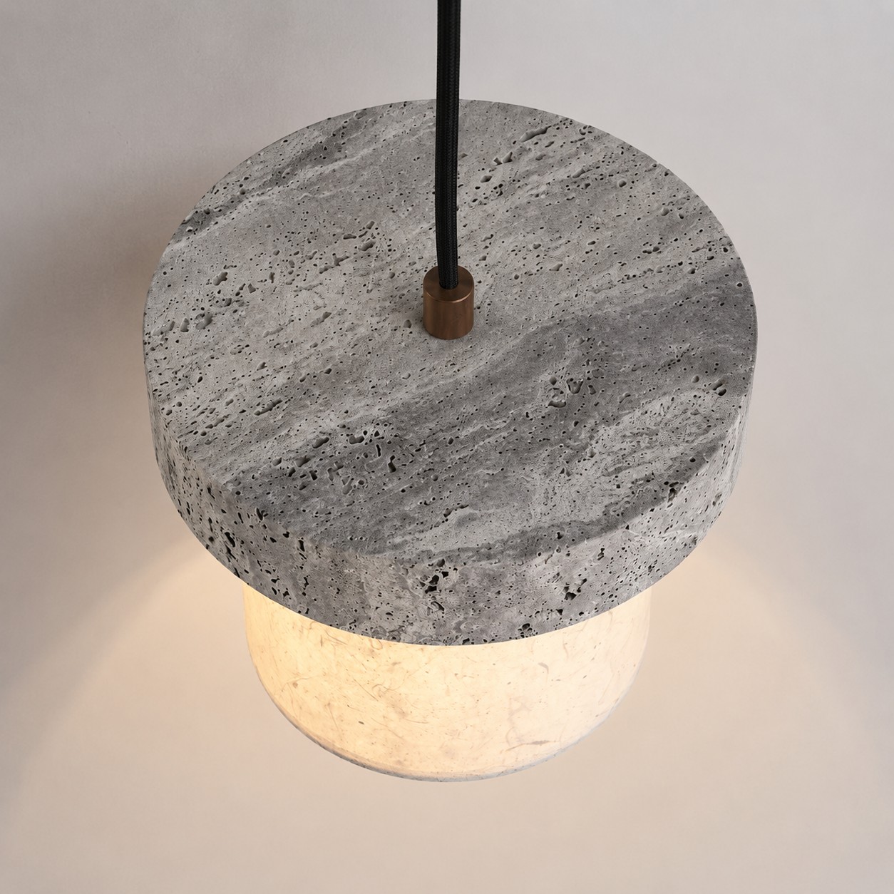 Top view of gray travertine stone pendant with cord connection