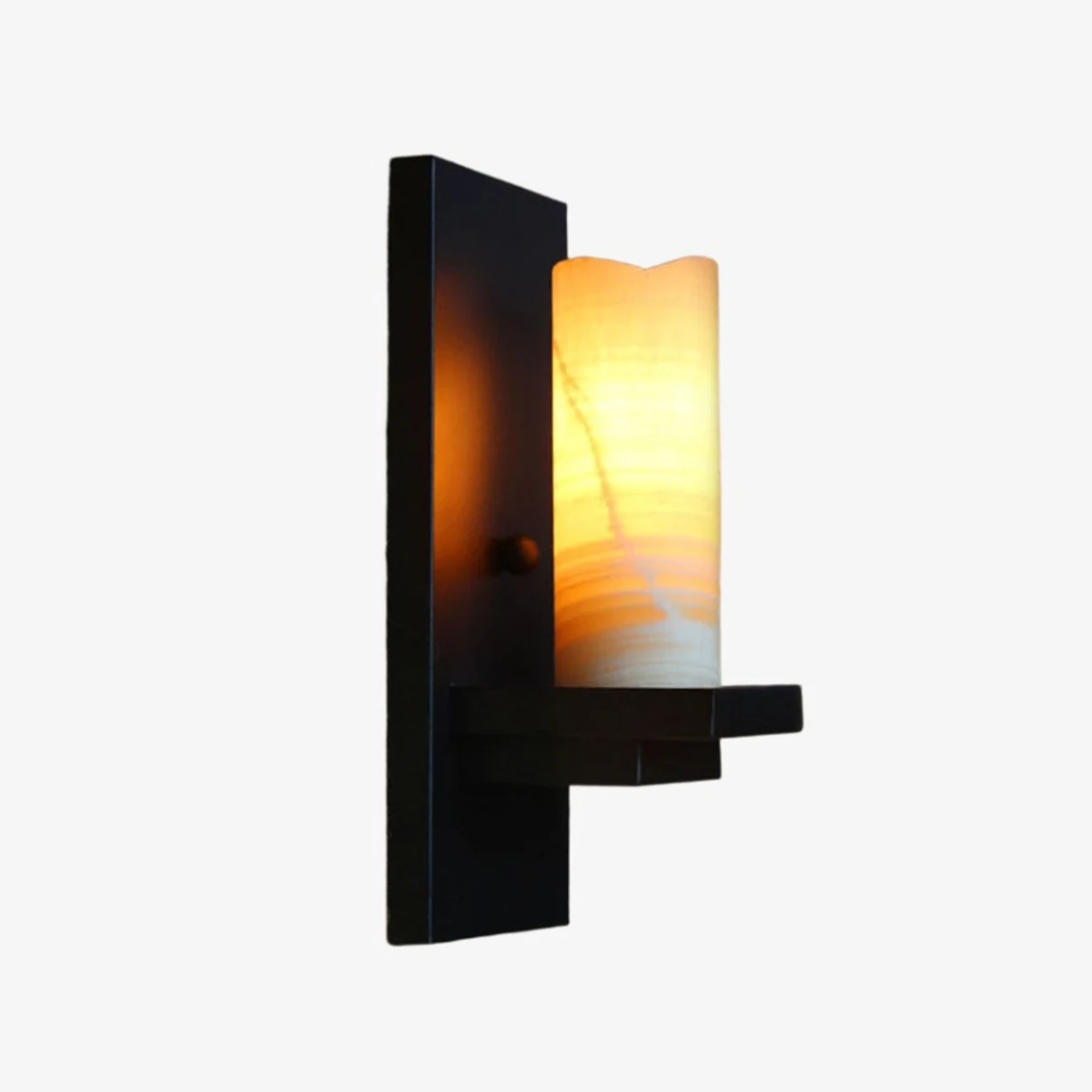 Black wall sconce with warm shade lit
