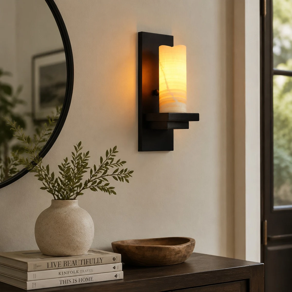 Compact wall sconce near a mirror and console