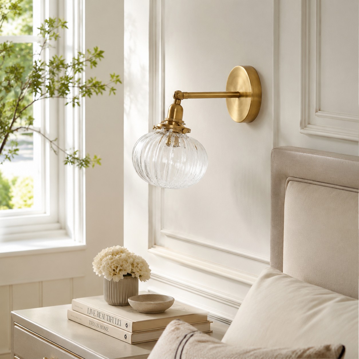 Antique brass ribbed glass wall sconce installed beside a bed