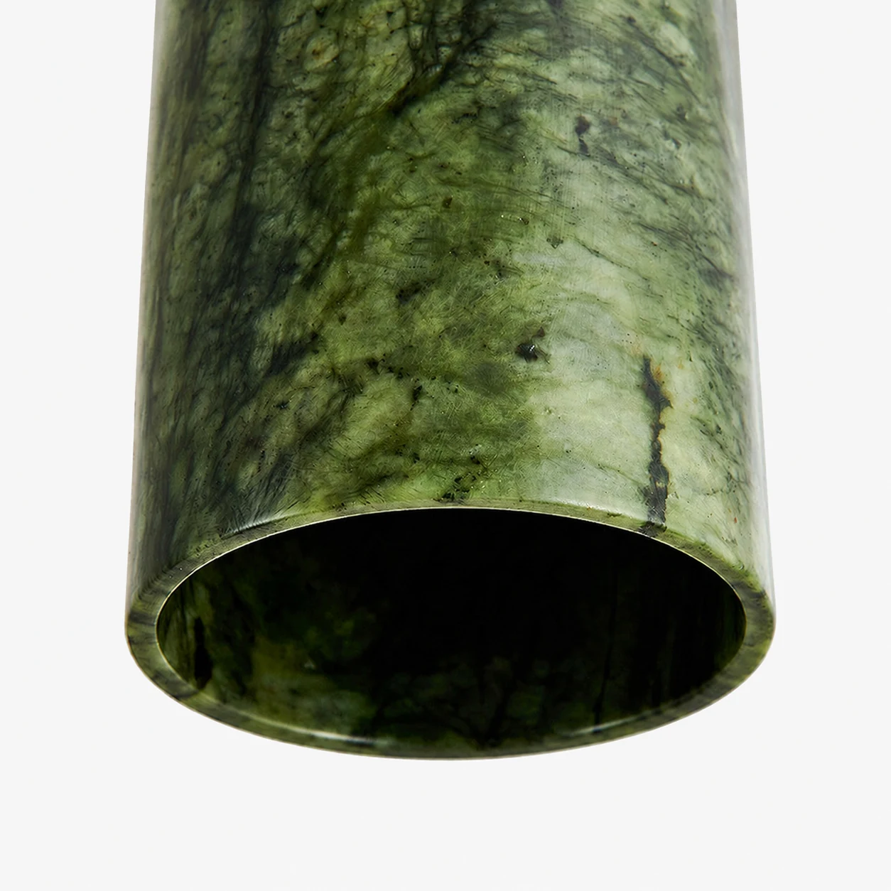Close view of the polished green jade cylinder shade texture and lower rim