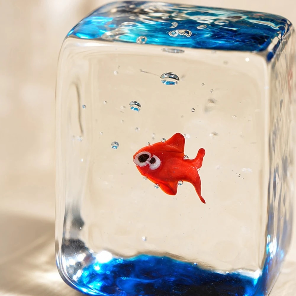 Close detail of clear glass block goldfish ornament