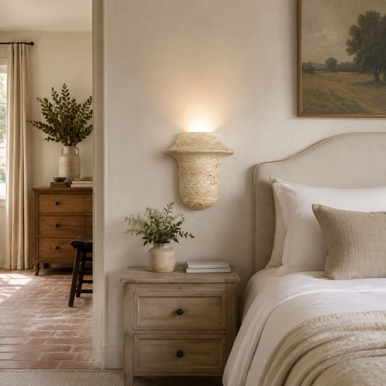 Travertine wall sconce used beside a bed as a warm bedside wall light