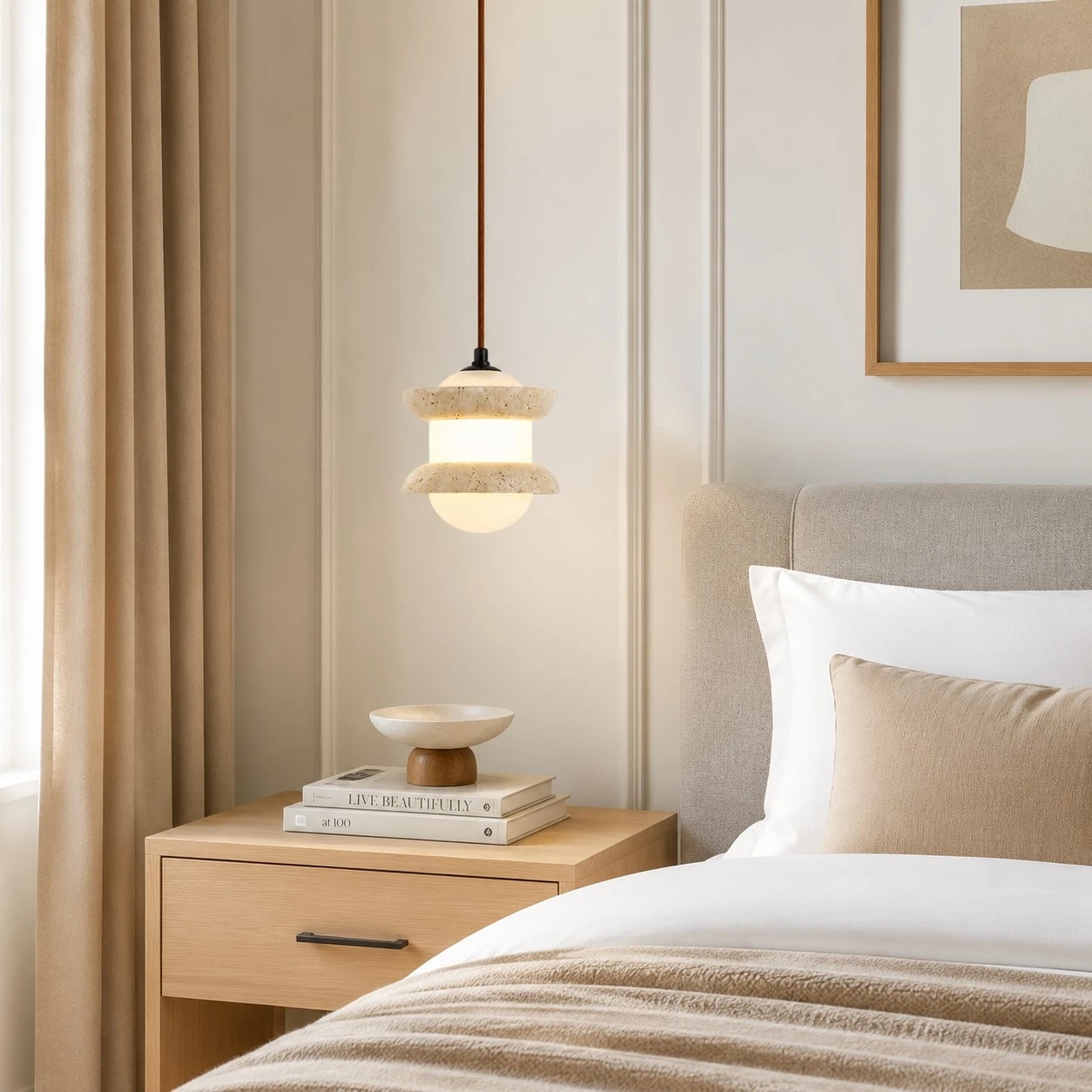 Single travertine stone pendant light beside a bed