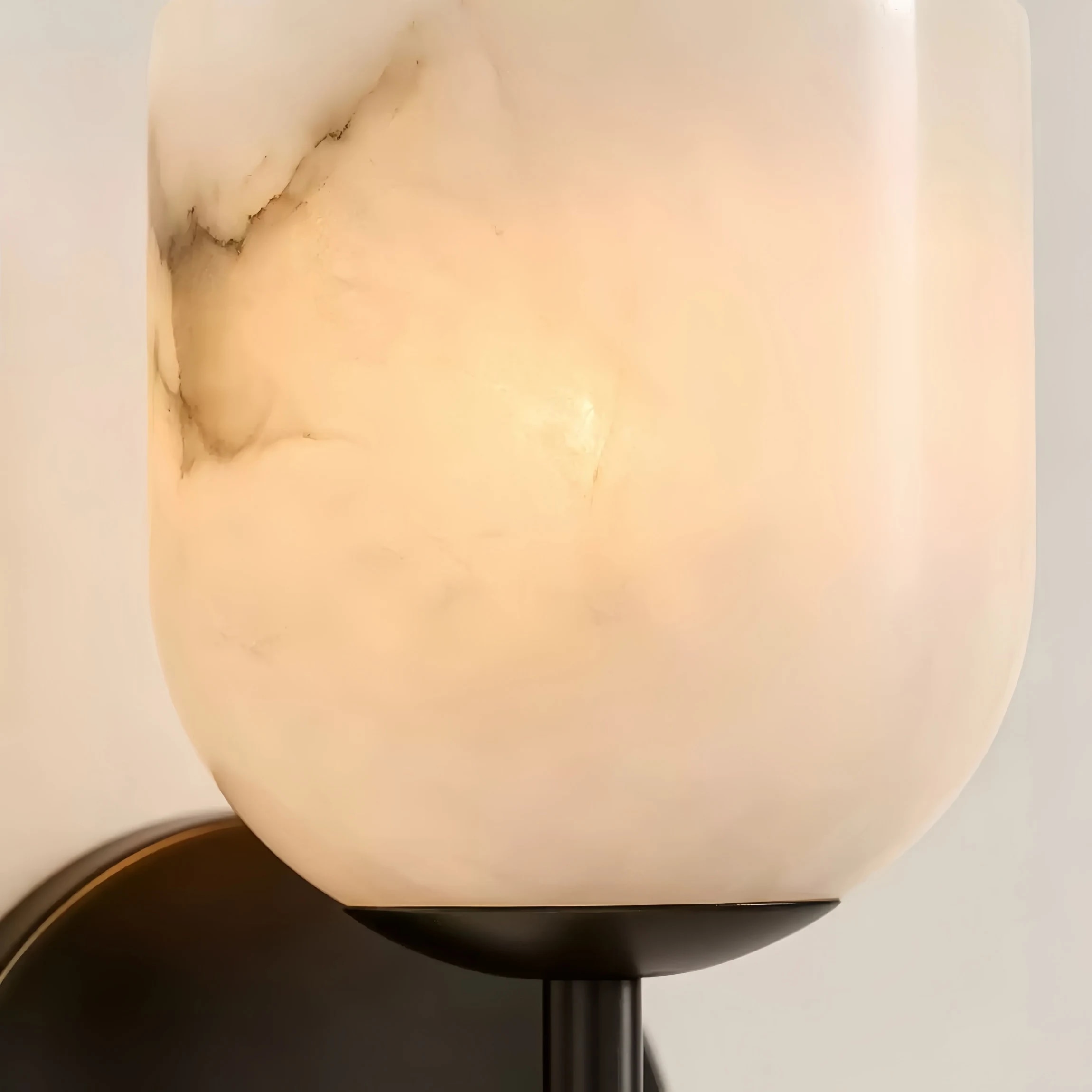 Close detail of white marble stone shade and warm glow