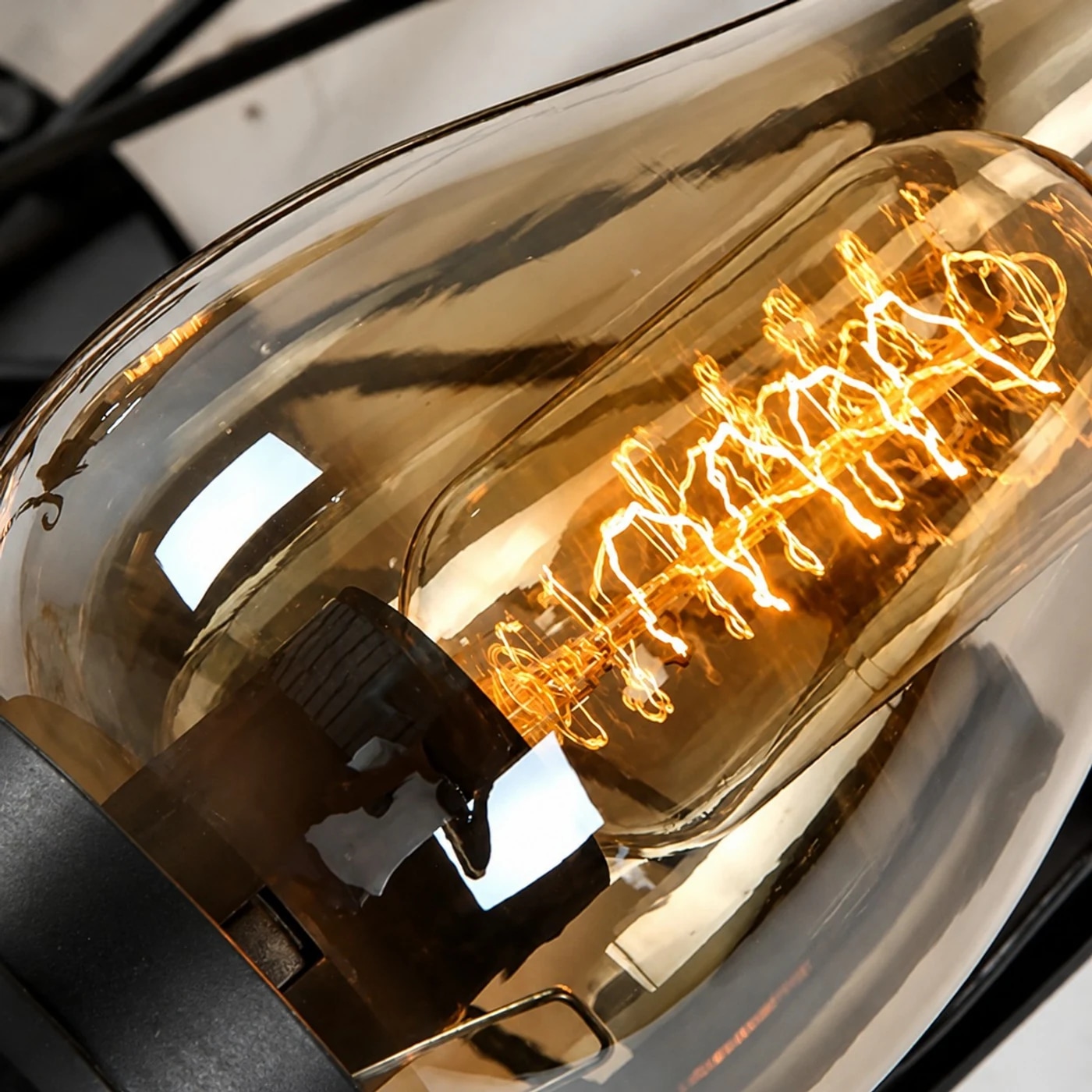 Amber glass chimney shade and warm filament bulb detail