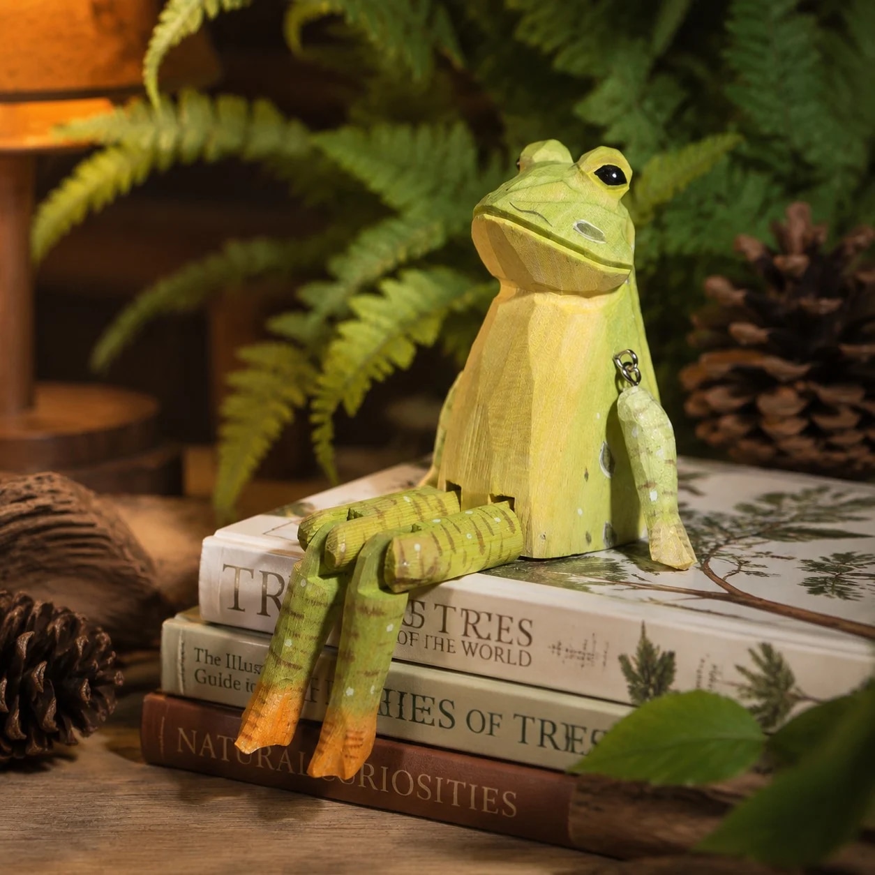 Hand-carved wooden frog ornament styled on a tabletop edge