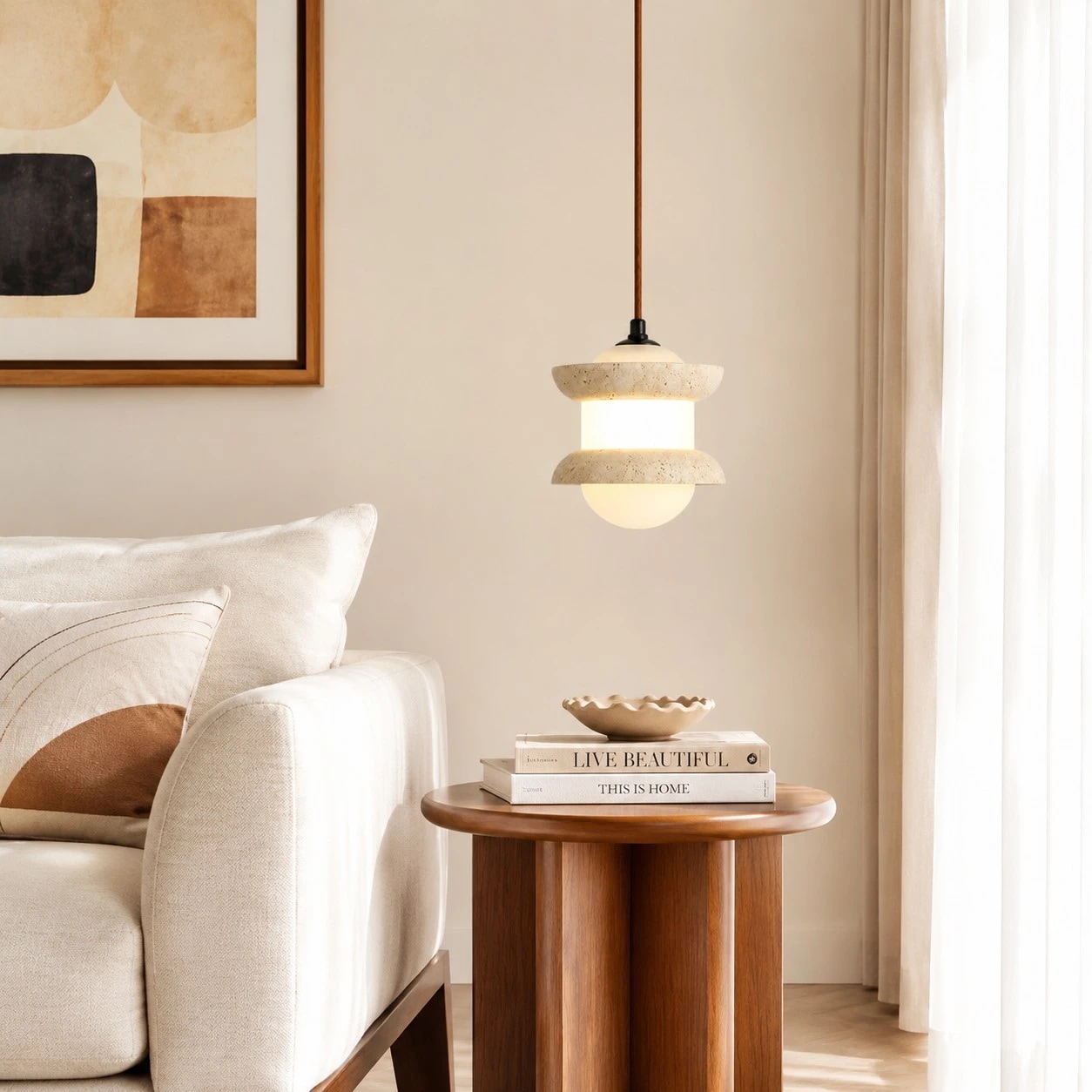 Single travertine stone pendant light beside a sofa and side table
