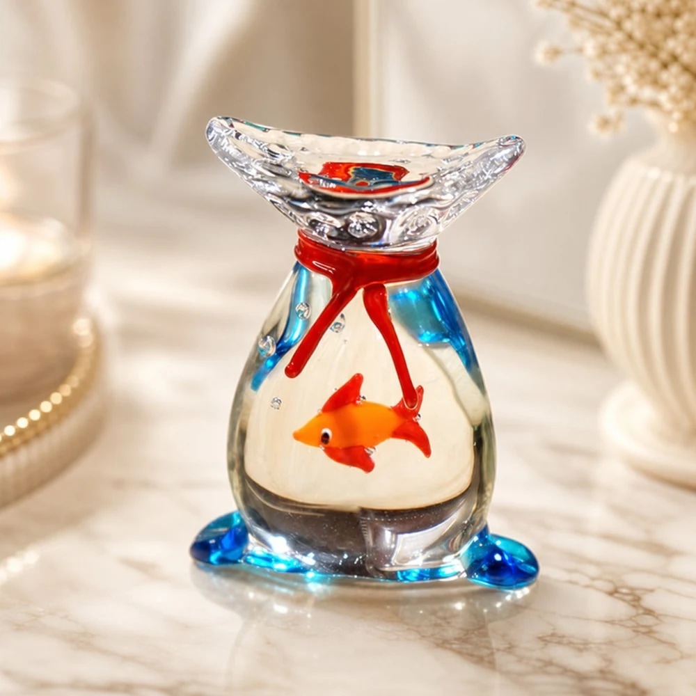 Rounded glass goldfish ornament on a tabletop