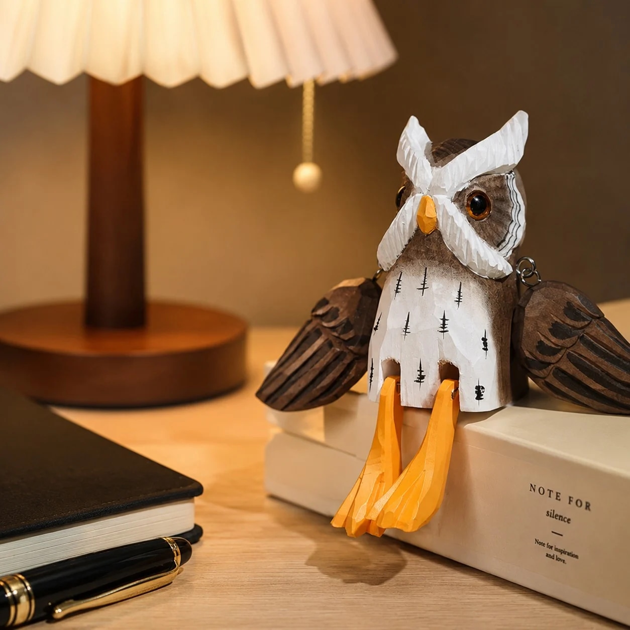 Hand-carved wooden hanging-leg owl ornament styled on a tabletop edge