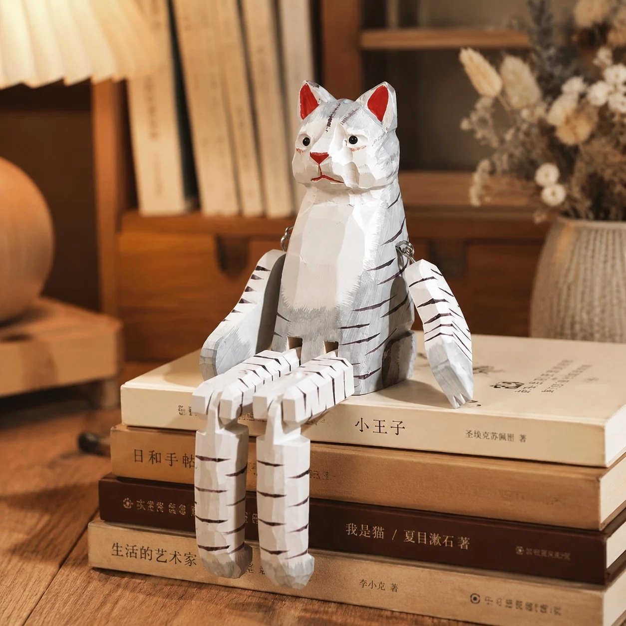 Hand-carved wooden cat ornament styled on a tabletop edge