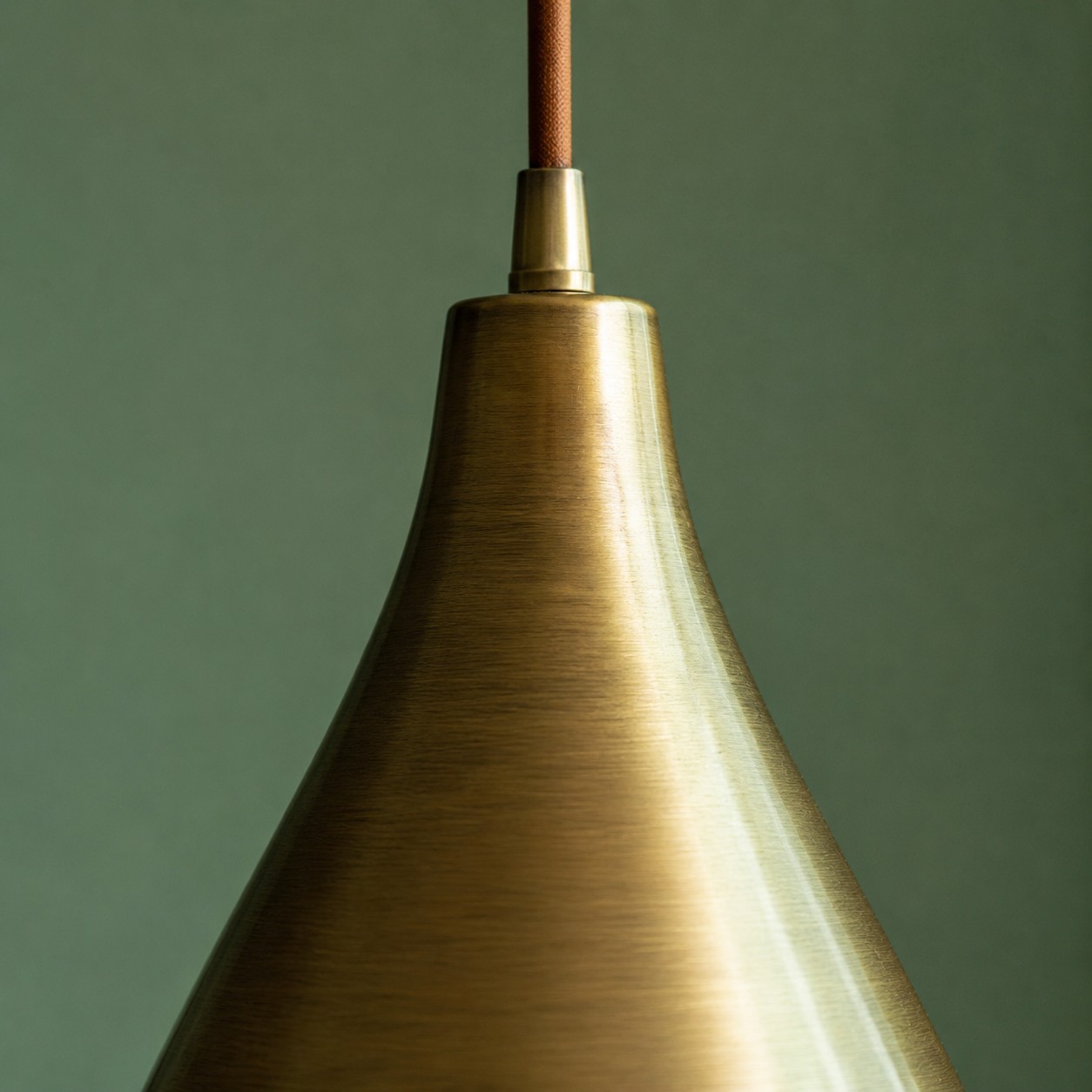 Close view of the brushed brass pendant surface