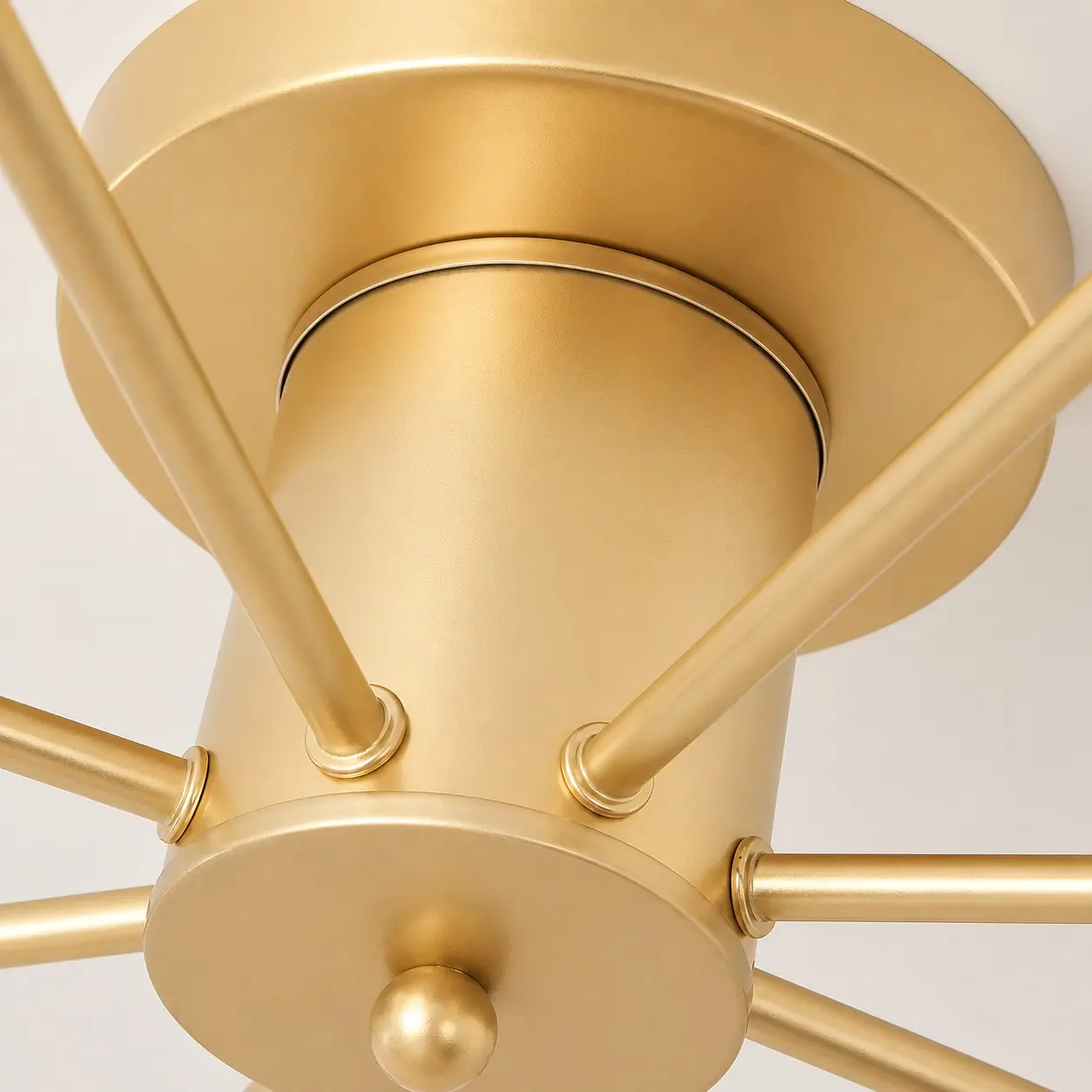 Close-up of the gold ceiling canopy and arm connections
