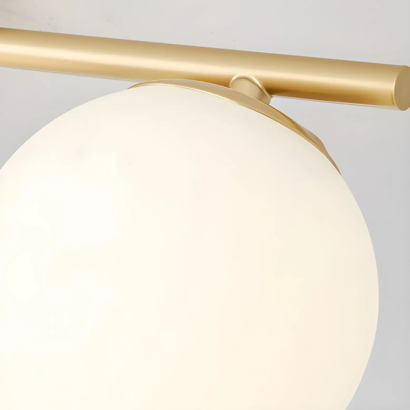 Gold metal bar and milk glass shade detail