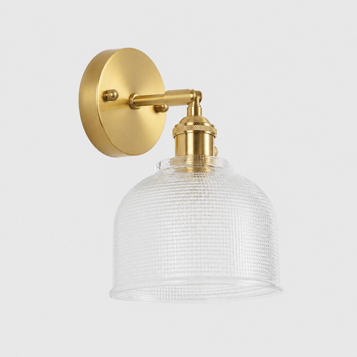Clear glass wall light with brass arm, CZ shade 11 cm high and 14 cm diameter