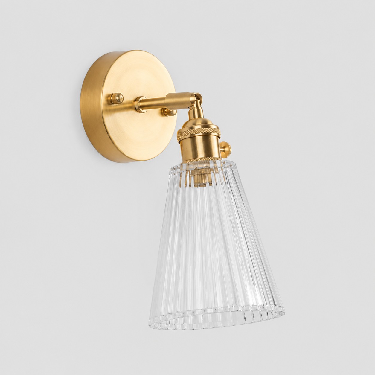 Clear glass wall light with brass arm, KZ shade 12 cm high and 13 cm diameter