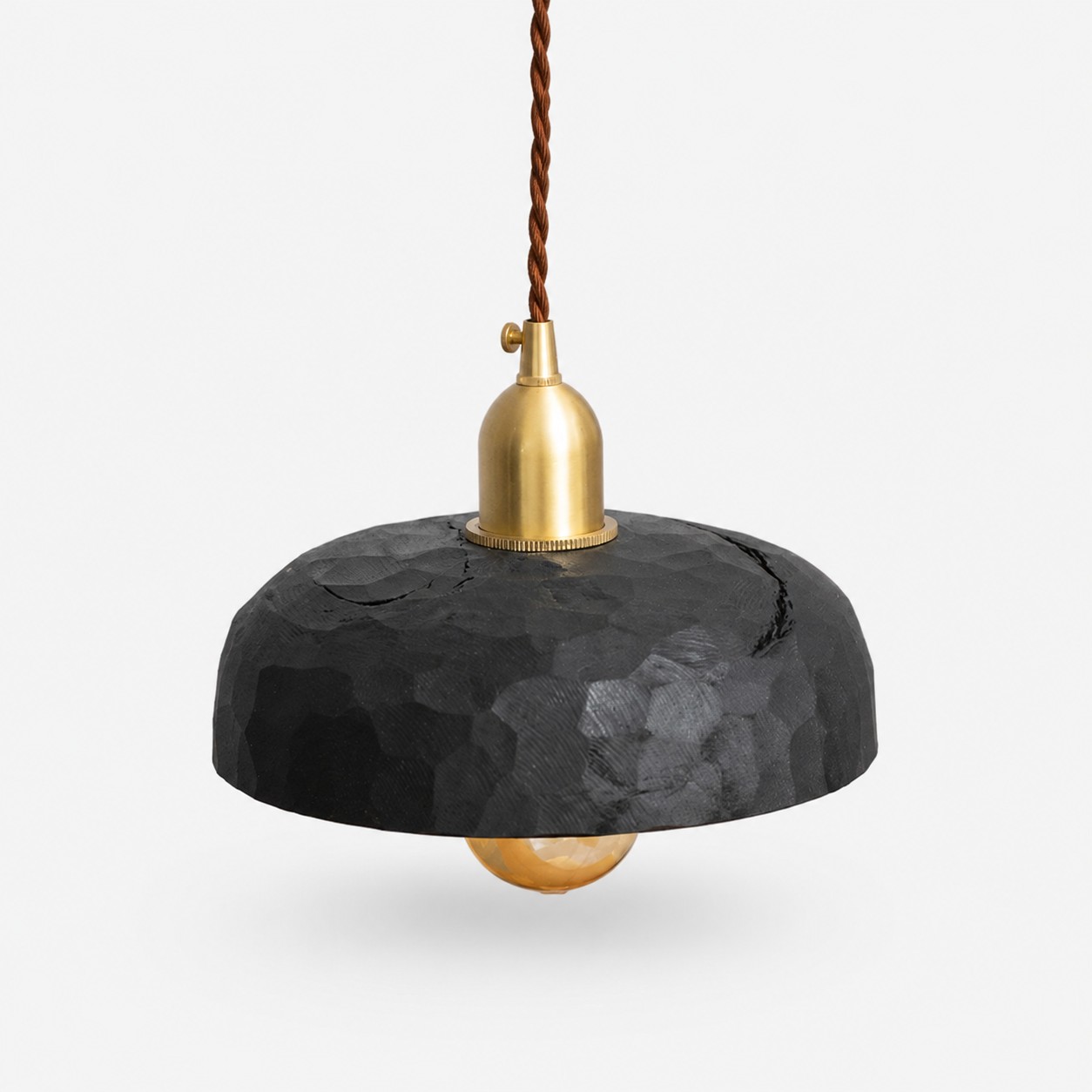Black carved wood pendant lamp on a clean background