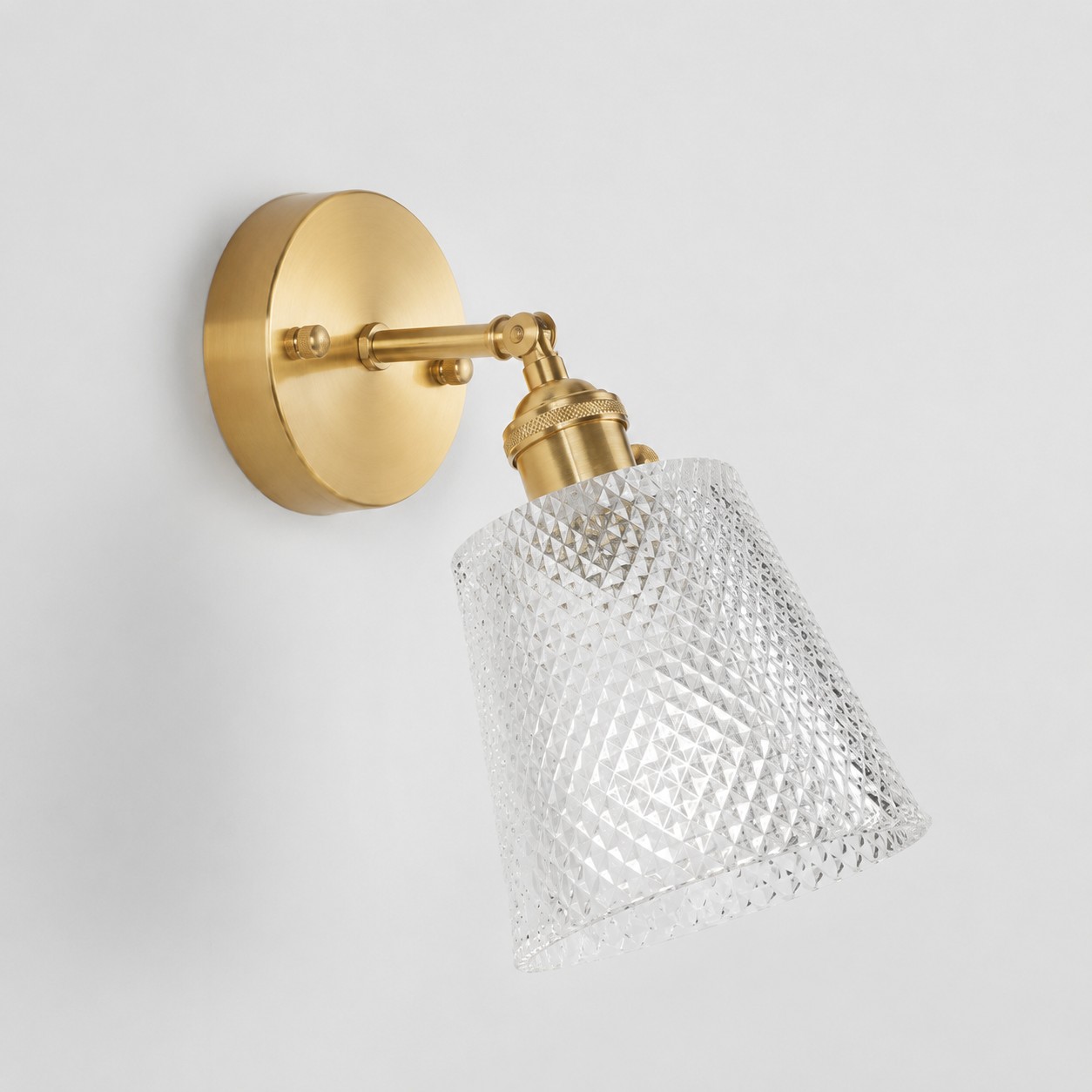 Clear glass wall light with brass arm, AZ shade 12 cm high and 13 cm diameter