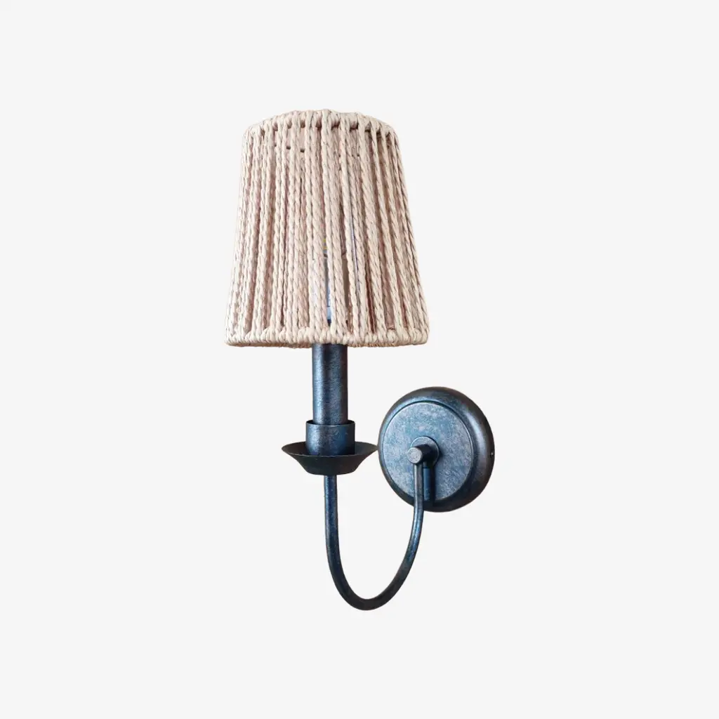 Antique brass wall sconce with C woven shade