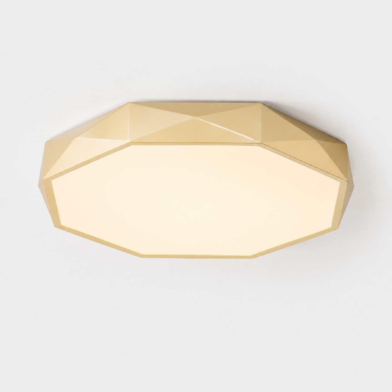 Gold faceted LED ceiling light in warm light viewed from below
