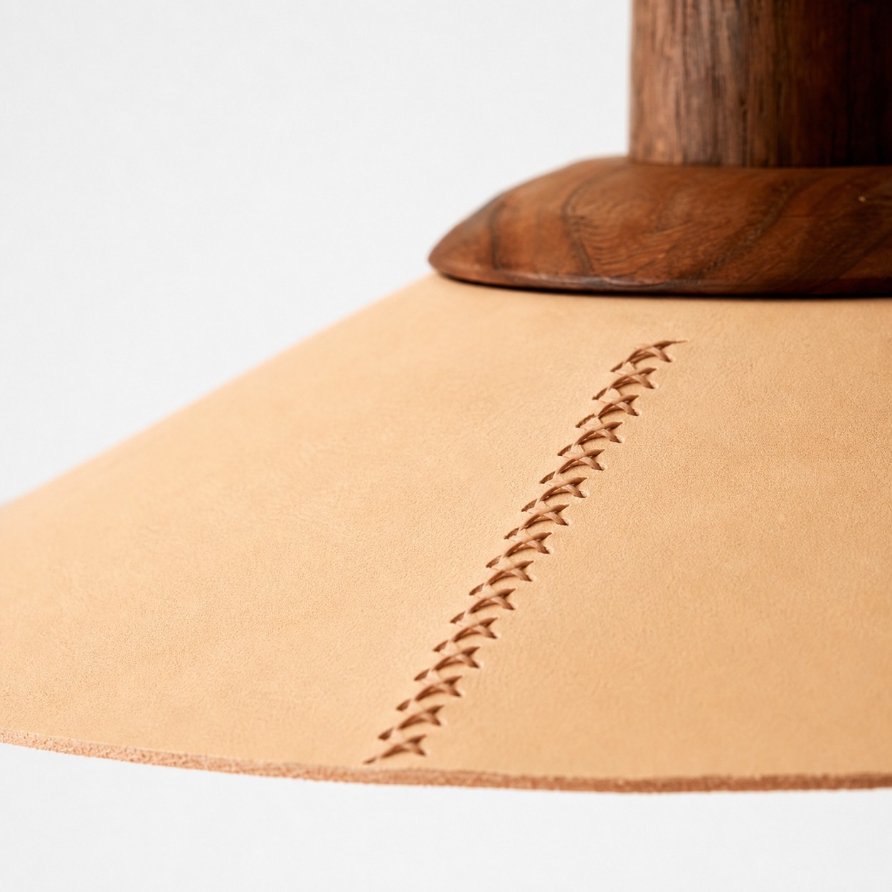 Natural leather shade with hand cross-stitching