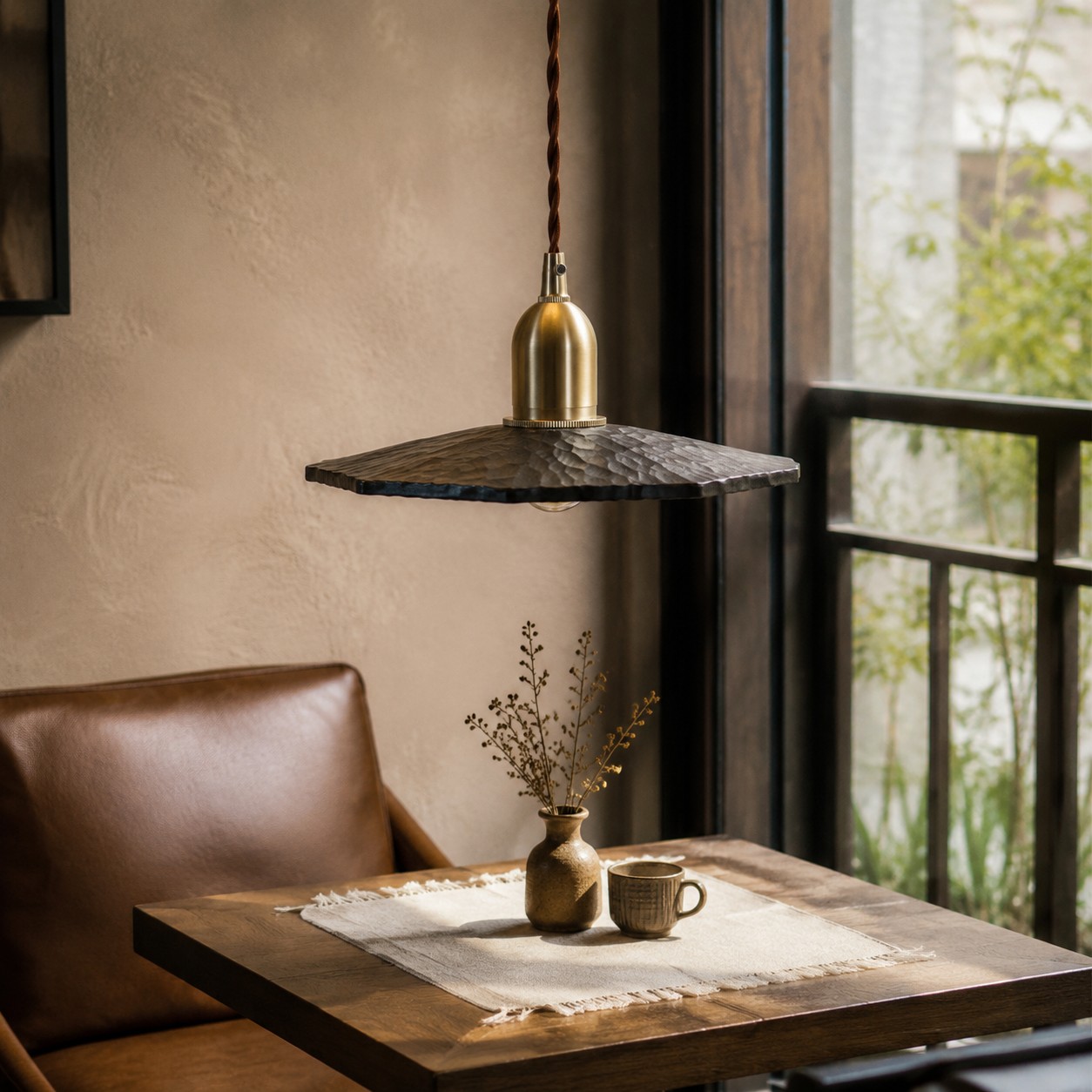 Octagonal wood pendant light over a small cafe table