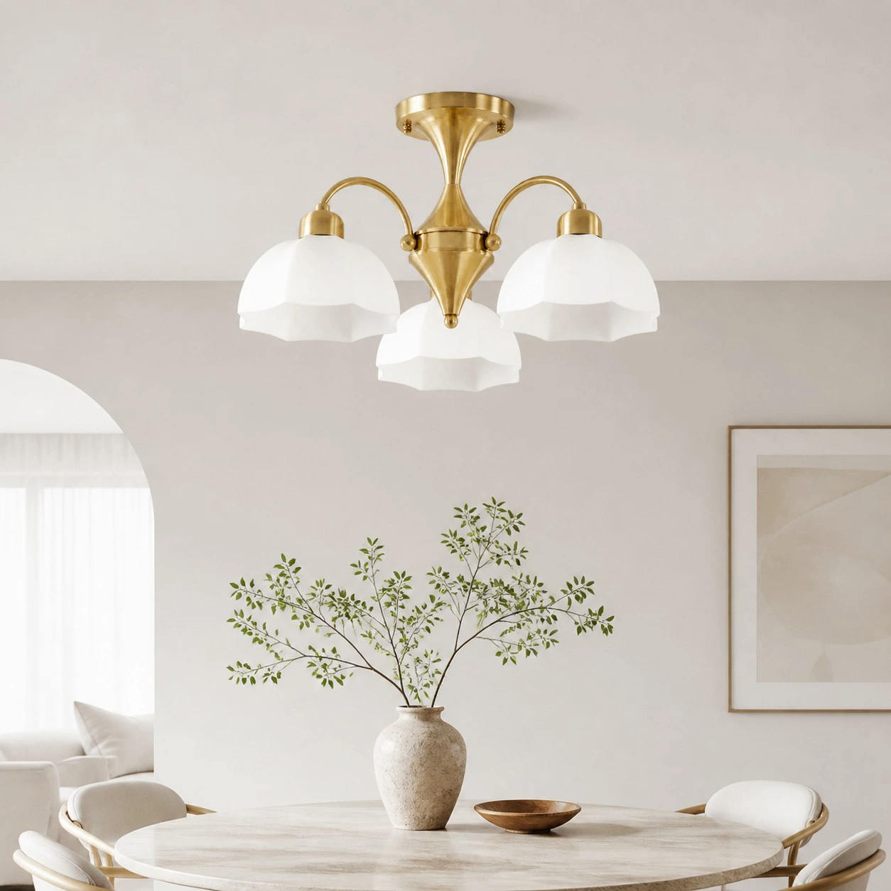 Three-light chandelier above a dining table in a bright interior
