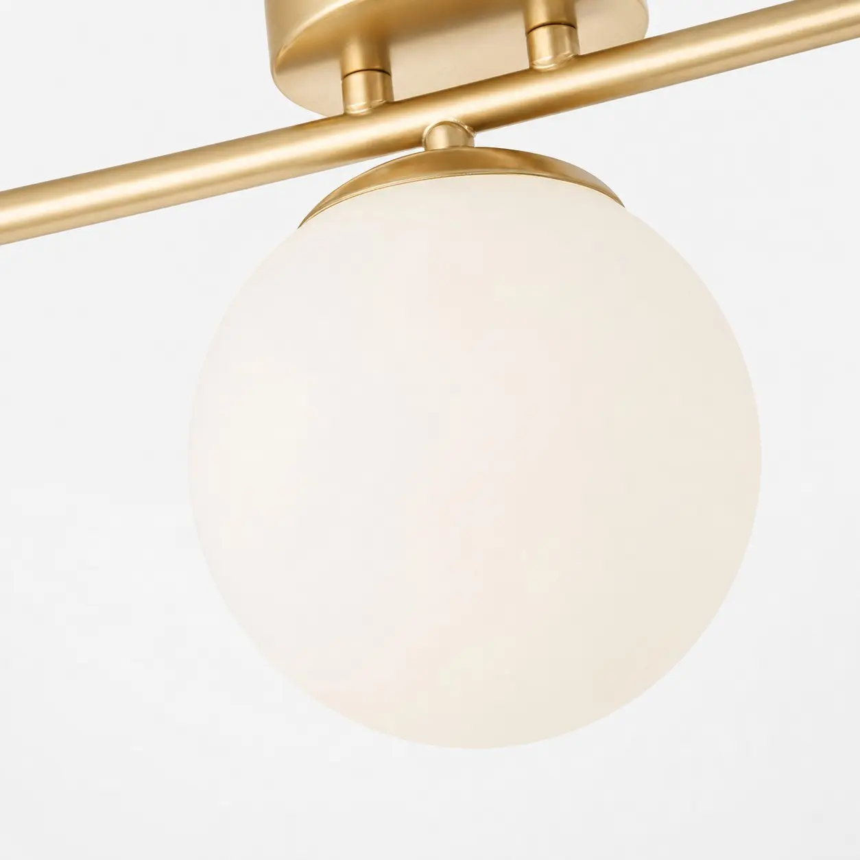 Milk glass shade and gold frame connection detail