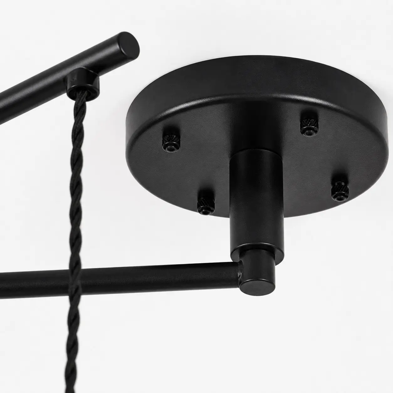 Black ceiling canopy and movable arm connection detail