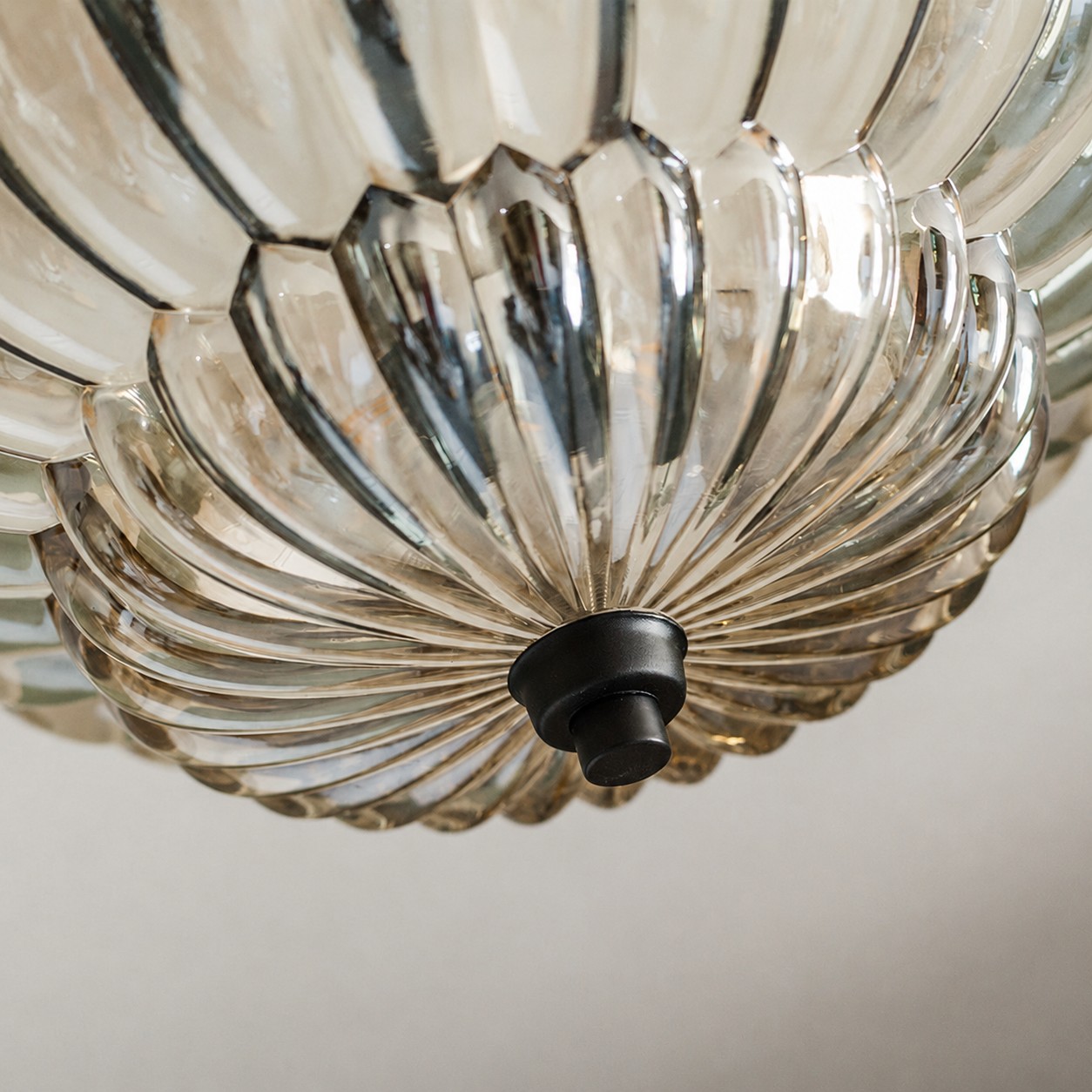 Lower glass bowl and dark finial detail