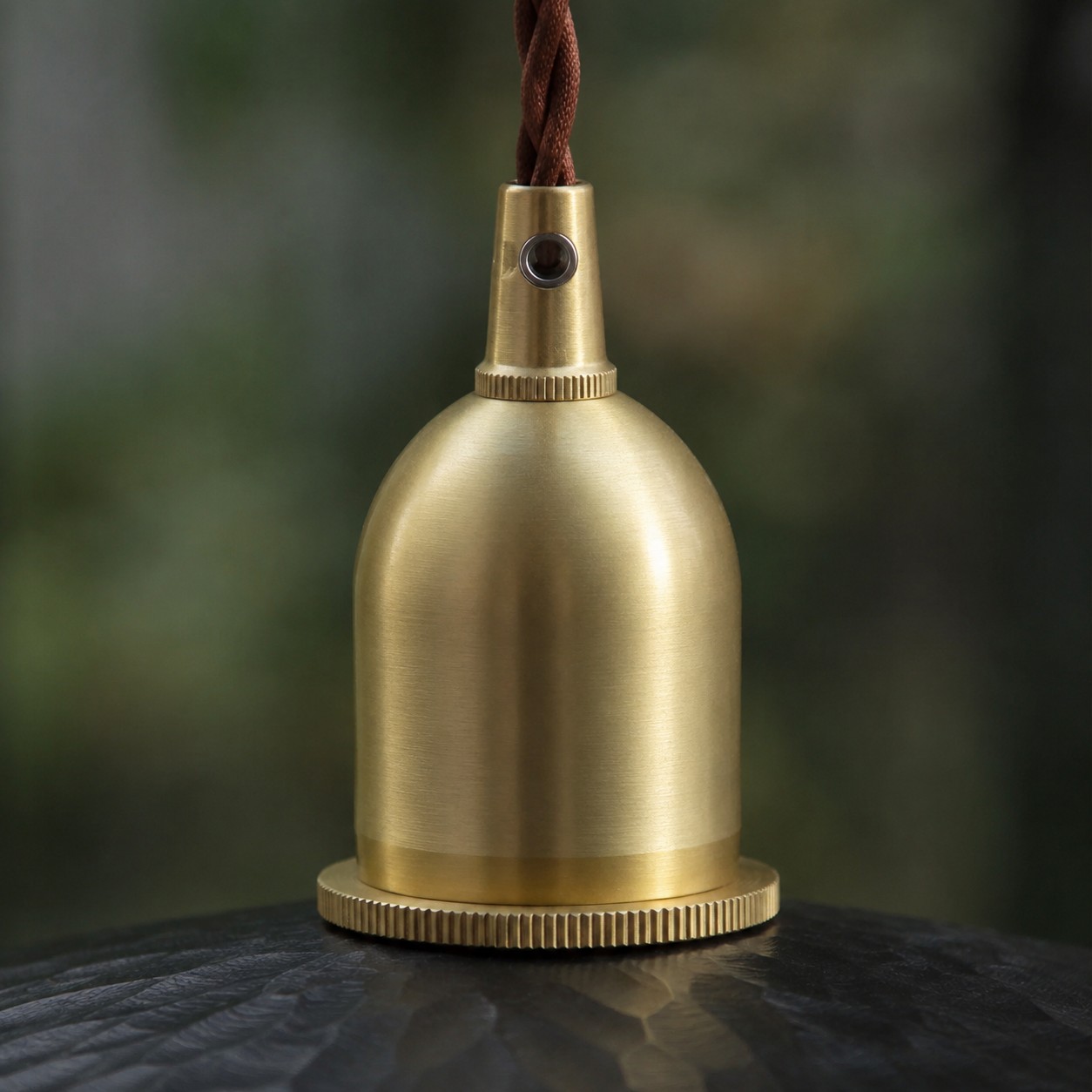 Brass tone holder detail on octagonal wood pendant light