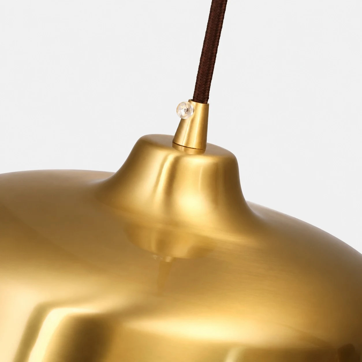 Close view of the bright brass surface and cord connection
