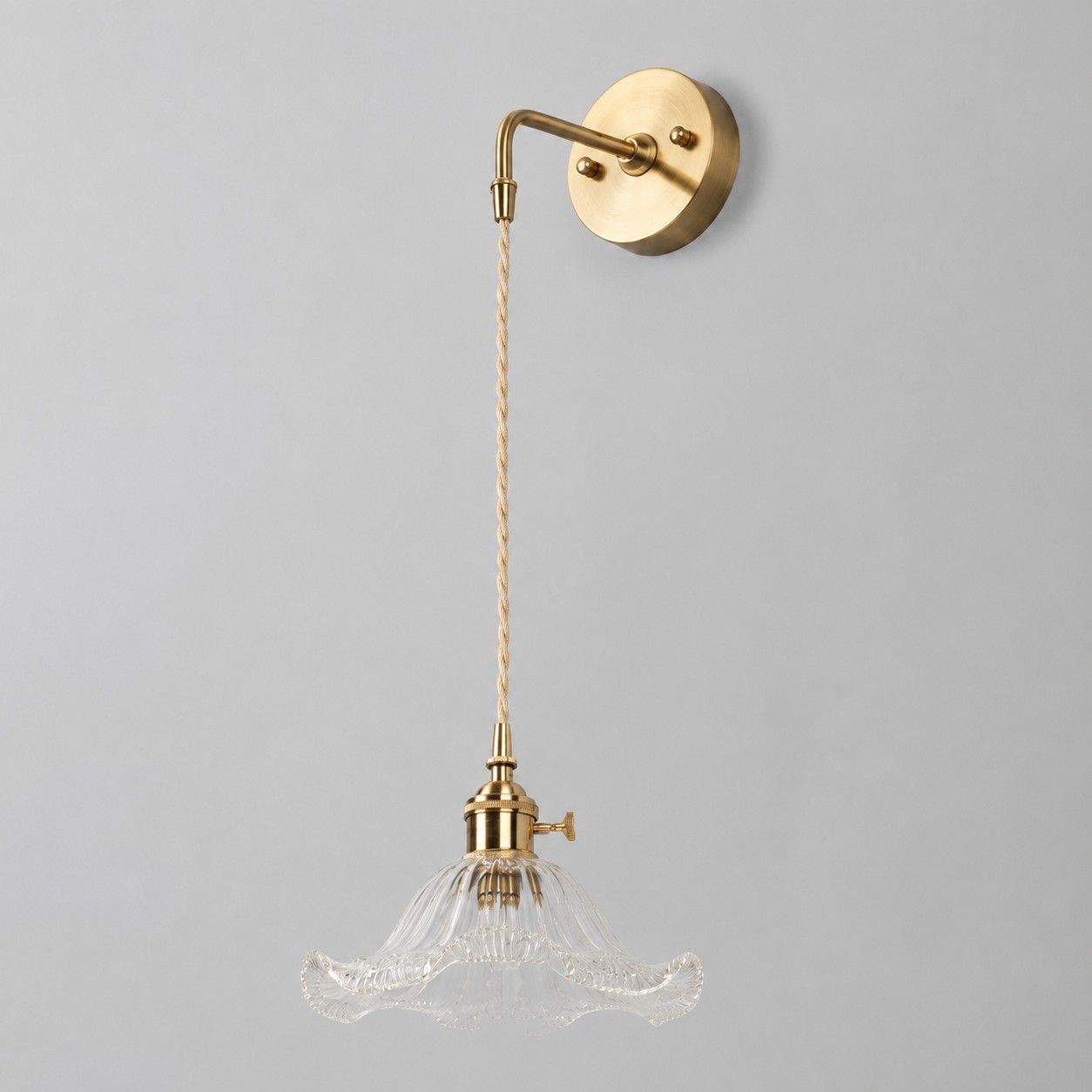 Clear glass wall light with brass arm, LW shade 19 cm diameter