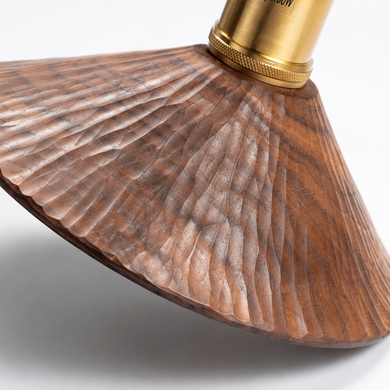Close-up of hand-carved wood grain on the wall sconce shade