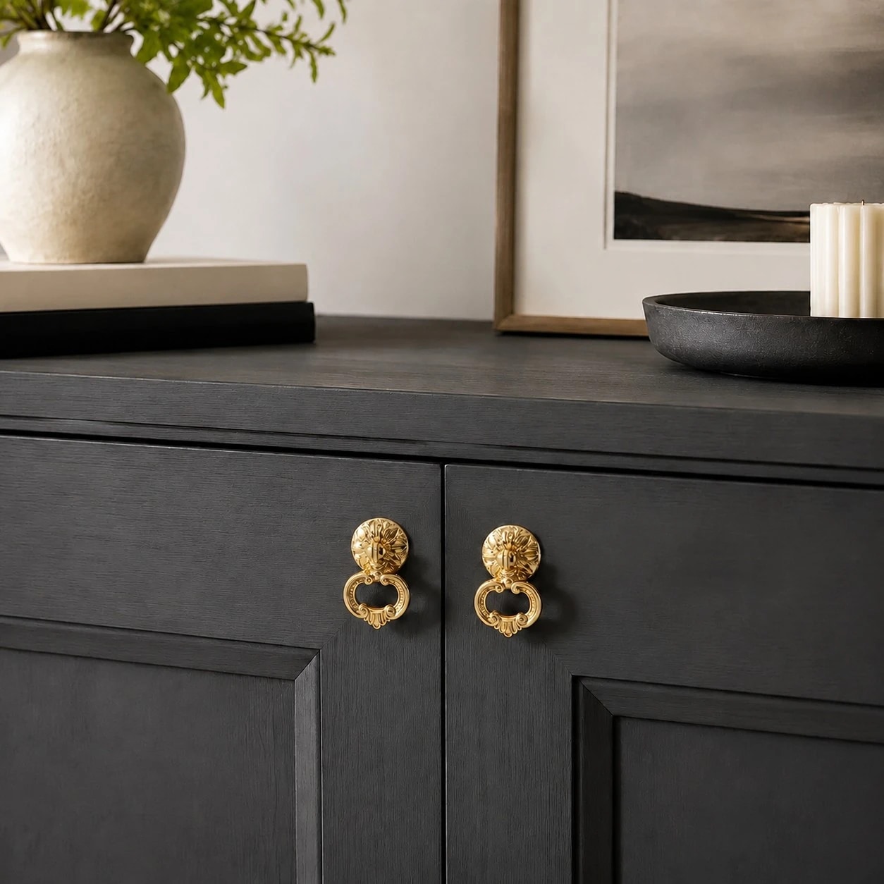 Brass ring pulls on a dark cabinet