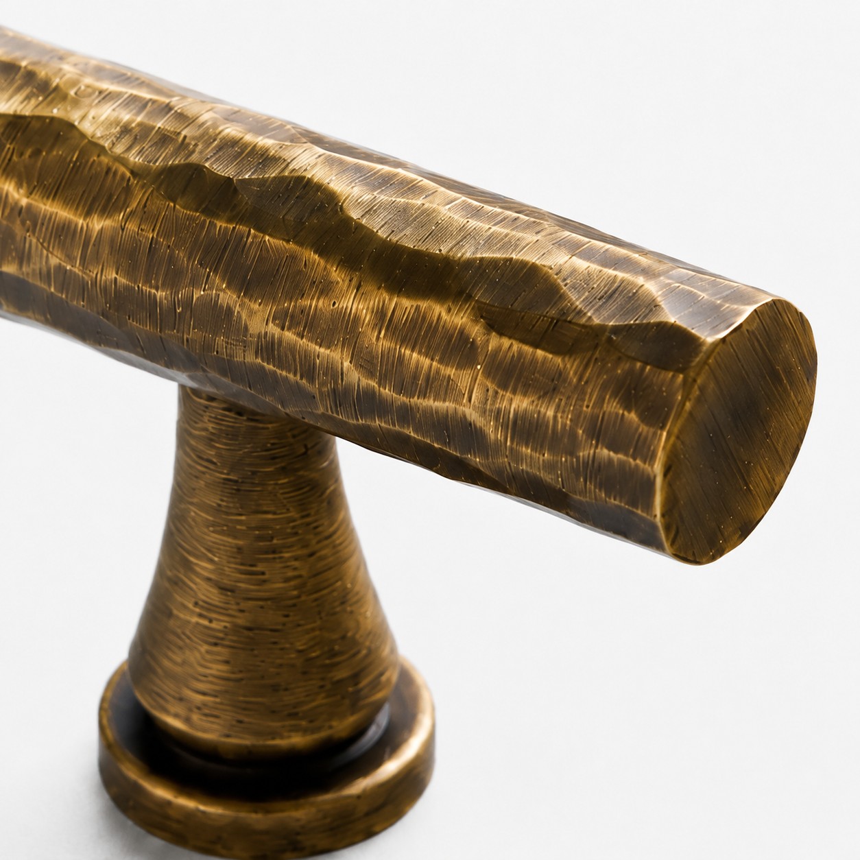 Close view of the Antique Brass T-Bar knob edge and mounting stem