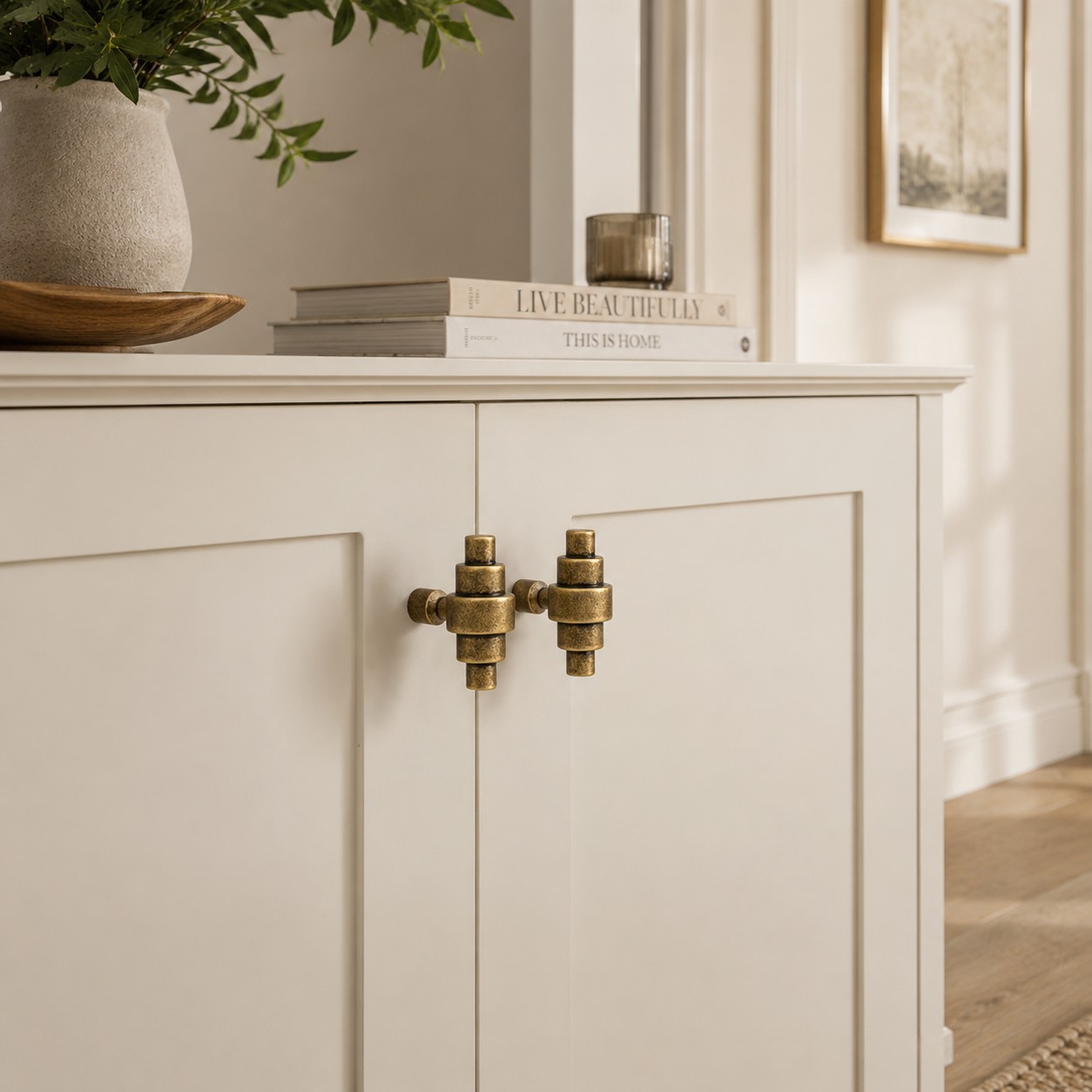 Paired antique brass handles on cabinet doors