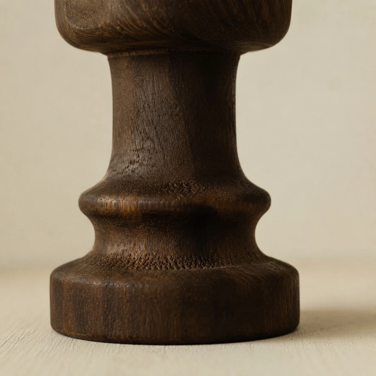 Close view of the solid wood candle holder silhouette and finish