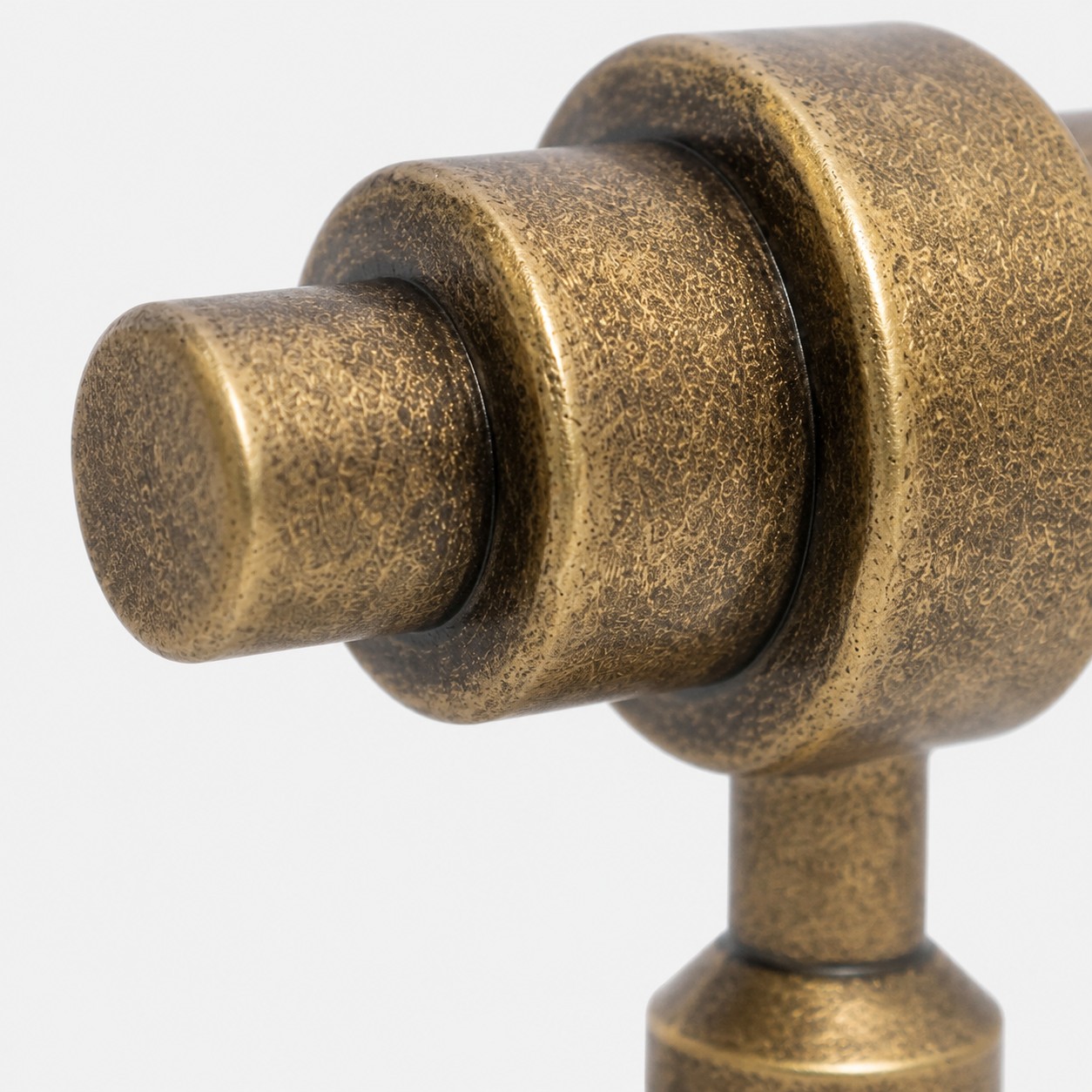 Rounded handle end and layered antique brass form